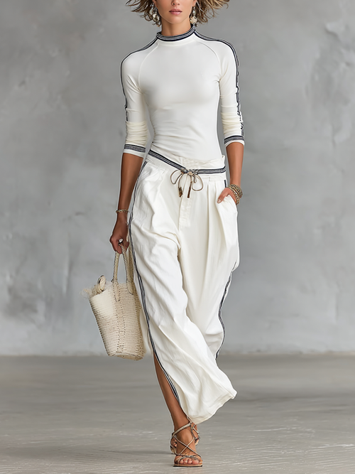 Completo da donna: T-shirt sportiva a maniche lunghe con collo alto e pantaloni larghi con cordoncino